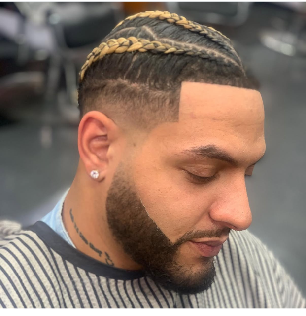 Detailed braided haircut with a clean fade by The Don LA